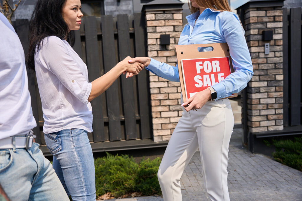 A door-to-door salesperson shaking hands with a client