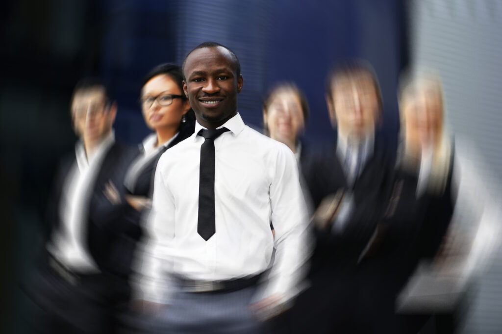 A leadership and management trainer with students in the background