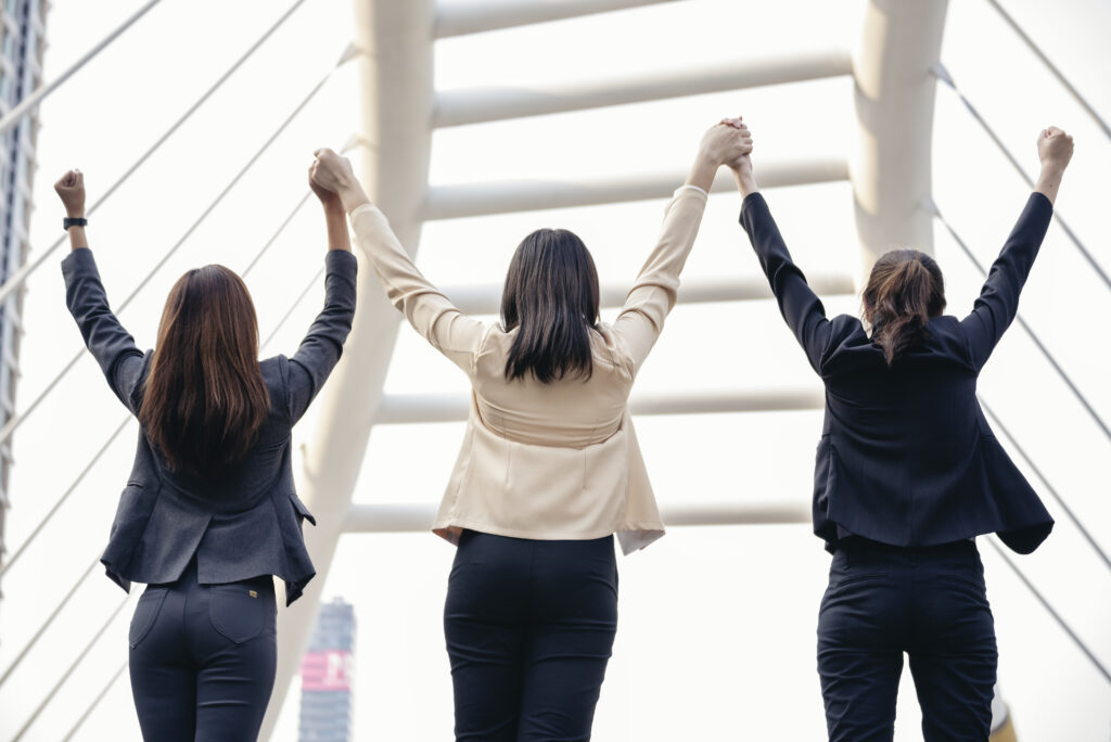 A group of professionals enjoying team success from overcoming obstacles